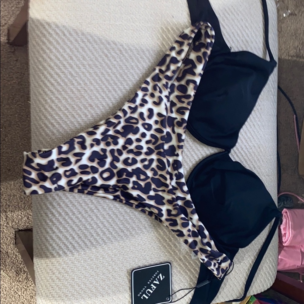 black bikini top and cheetah bikini bottom